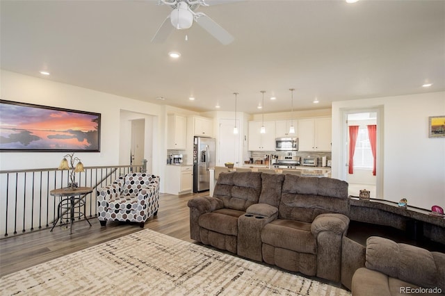 living room with recessed lighting and wood finished floors