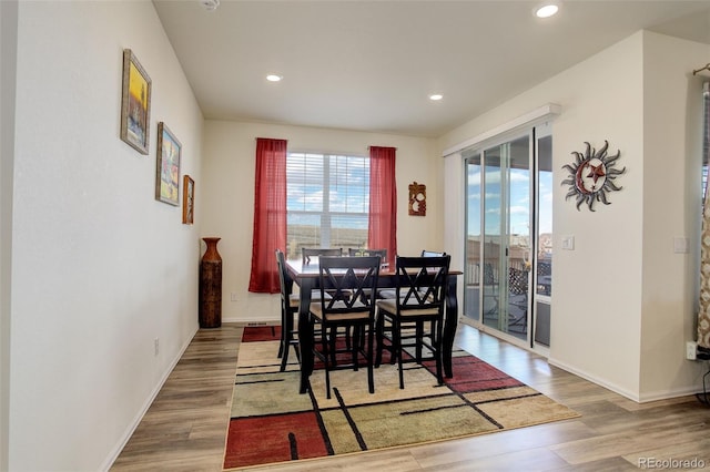 dining room featuring recessed lighting, baseboards, and wood finished floors