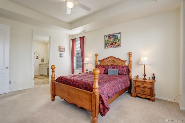 carpeted bedroom featuring ensuite bathroom, ceiling fan, and baseboards