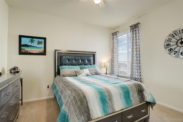 bedroom featuring baseboards, a ceiling fan, and light colored carpet