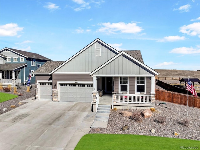 view of front of property featuring a porch, driveway, board and batten siding, and a garage