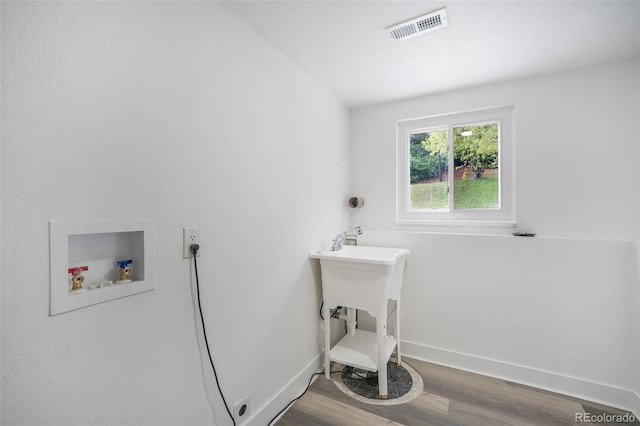 11172 W Exposition Dr, Denver, CO 80226 - washroom featuring washer hookup, wood finished floors, and baseboards