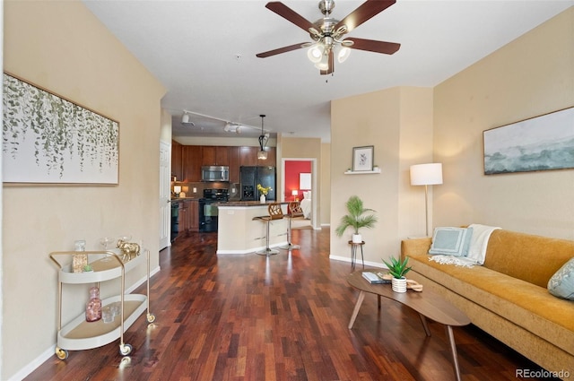 2662 S Cathay Way Unit 112, Aurora, CO 80013 - living area with dark wood-style floors, ceiling fan, baseboards, and rail lighting