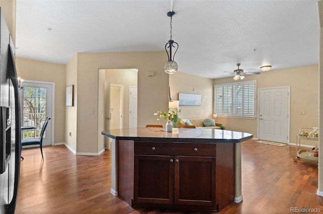 2662 S Cathay Way Unit 112, Aurora, CO 80013 - kitchen with fridge with ice dispenser, wood finished floors, pendant lighting, dark brown cabinets, and a ceiling fan