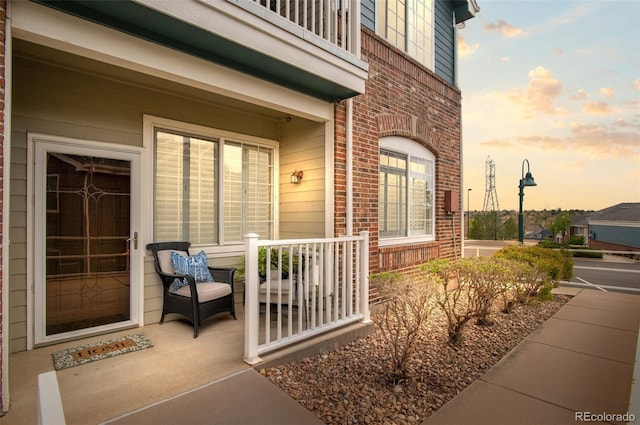 2662 S Cathay Way Unit 112, Aurora, CO 80013 - exterior entry at dusk with brick siding and covered porch