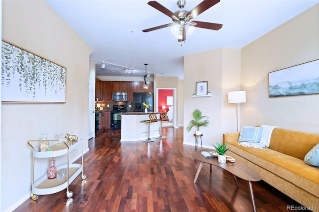 2662 S Cathay Way Unit 112, Aurora, CO 80013 - living room with dark wood-type flooring, baseboards, and ceiling fan