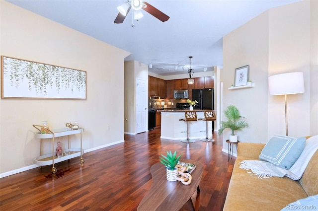 2662 S Cathay Way Unit 112, Aurora, CO 80013 - living area with dark wood-type flooring, ceiling fan, and baseboards