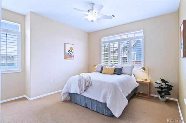 2662 S Cathay Way Unit 112, Aurora, CO 80013 - bedroom featuring multiple windows, baseboards, carpet flooring, and a ceiling fan