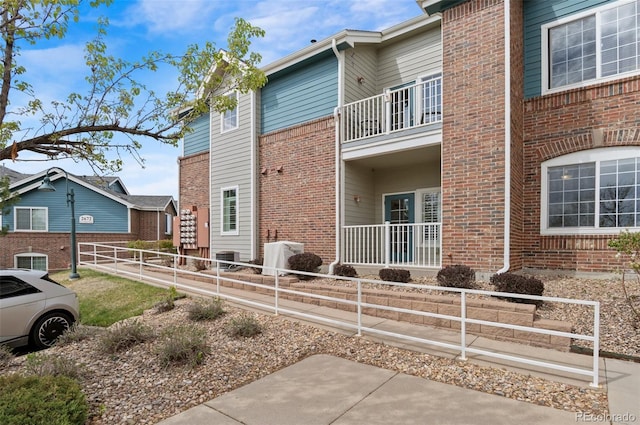 2662 S Cathay Way Unit 112, Aurora, CO 80013 - view of property exterior featuring a balcony and brick siding