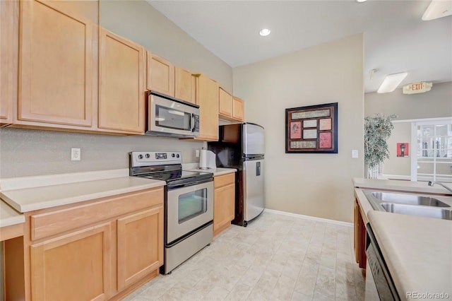 2662 S Cathay Way Unit 112, Aurora, CO 80013 - kitchen featuring stainless steel appliances, light brown cabinetry, a sink, recessed lighting, and light countertops