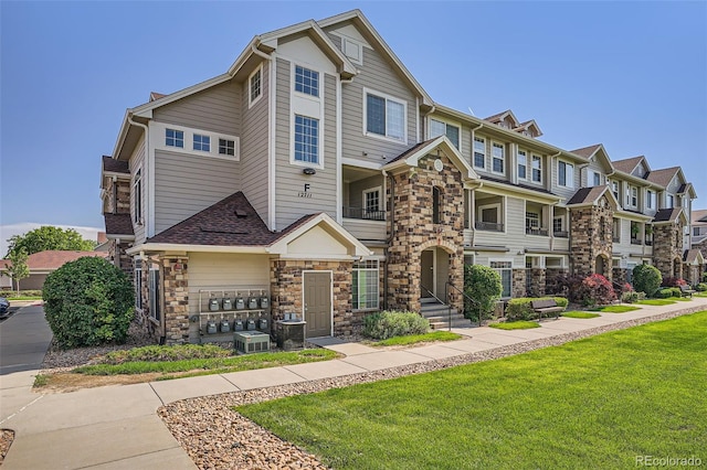 12711 Colorado Blvd Unit 607F, Thornton, CO 80241 - view of property featuring stone siding, a front yard, and a residential view