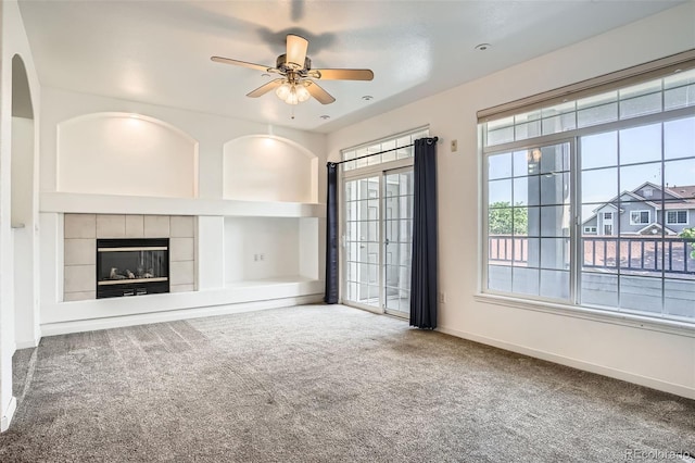 12711 Colorado Blvd Unit 607F, Thornton, CO 80241 - unfurnished living room with carpet, ceiling fan, a tile fireplace, and built in shelves