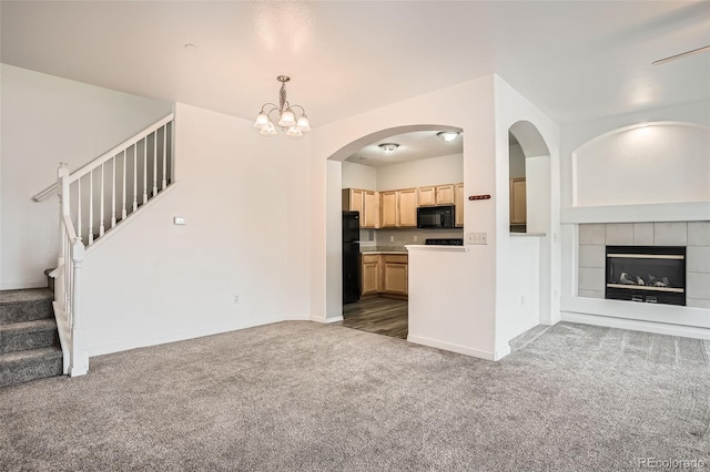 12711 Colorado Blvd Unit 607F, Thornton, CO 80241 - unfurnished living room with carpet flooring, stairway, a chandelier, and a tile fireplace