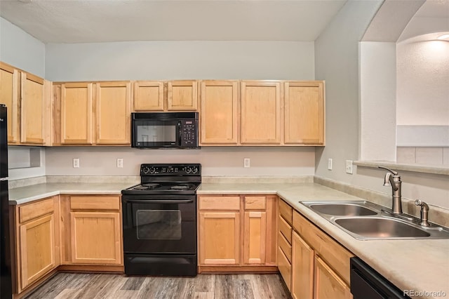12711 Colorado Blvd Unit 607F, Thornton, CO 80241 - kitchen with black appliances, light brown cabinetry, light wood finished floors, and light countertops