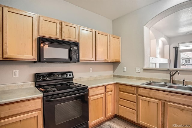12711 Colorado Blvd Unit 607F, Thornton, CO 80241 - kitchen featuring black appliances, light brown cabinets, light wood-type flooring, and light countertops