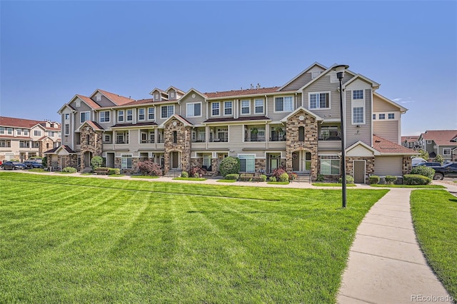 12711 Colorado Blvd Unit 607F, Thornton, CO 80241 - multi unit property with stone siding, a residential view, and a front lawn