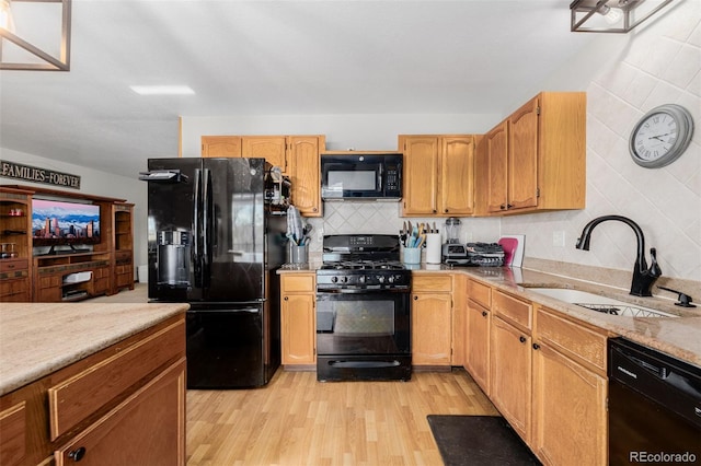 35055 E Mississippi Ave, Watkins, CO 80137 - kitchen featuring light wood-type flooring, decorative backsplash, black appliances, and a sink