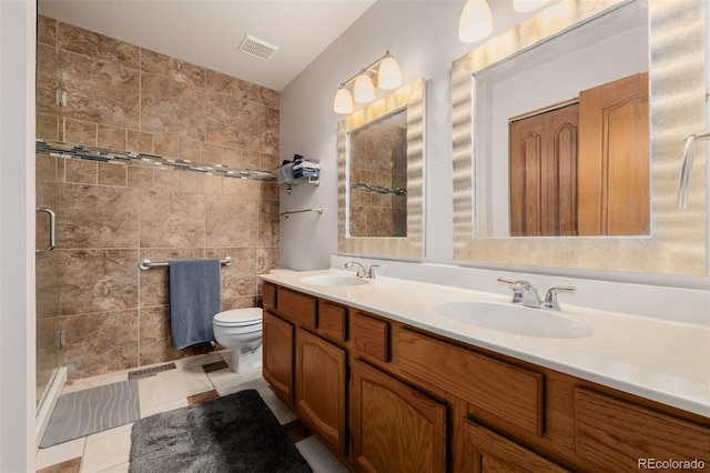 35055 E Mississippi Ave, Watkins, CO 80137 - bathroom featuring a sink, toilet, visible vents, a stall shower, and double vanity