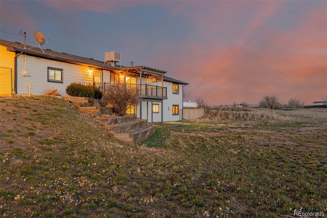 35055 E Mississippi Ave, Watkins, CO 80137 - back of house at dusk featuring a balcony
