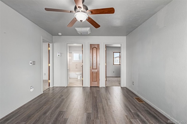 35055 E Mississippi Ave, Watkins, CO 80137 - unfurnished bedroom featuring connected bathroom, baseboards, visible vents, and wood finished floors