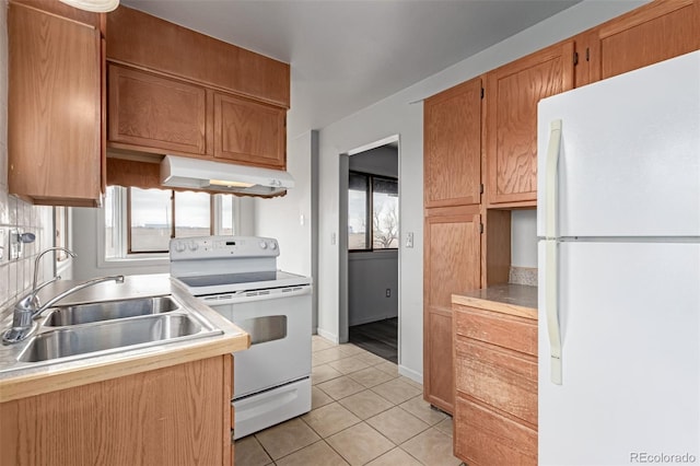 35055 E Mississippi Ave, Watkins, CO 80137 - kitchen with light tile patterned floors, a sink, white appliances, under cabinet range hood, and light countertops