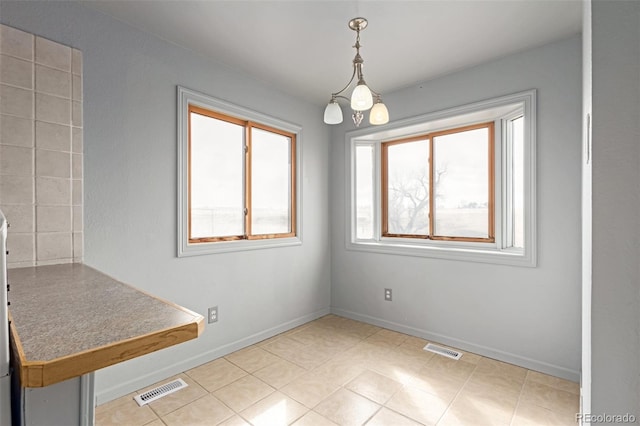 35055 E Mississippi Ave, Watkins, CO 80137 - unfurnished dining area featuring baseboards, light tile patterned floors, and visible vents