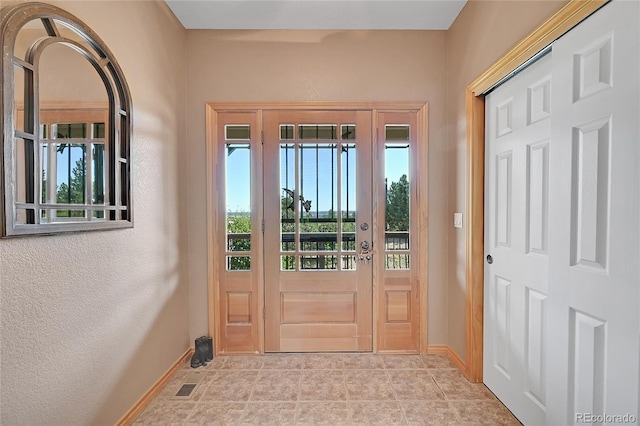 doorway featuring light tile patterned flooring