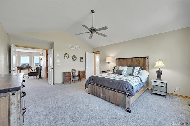 carpeted bedroom featuring lofted ceiling and ceiling fan