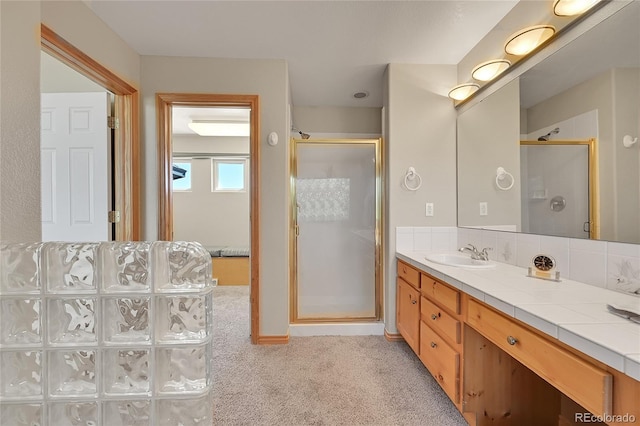 bathroom featuring vanity and a shower with door