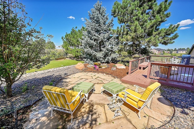 view of yard with a deck and a patio