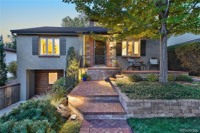 view of front of home with covered porch and stucco siding