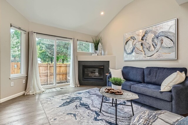 5150 Buckingham Rd, Boulder, CO 80301 - living area featuring lofted ceiling, plenty of natural light, a glass covered fireplace, wood finished floors, and recessed lighting