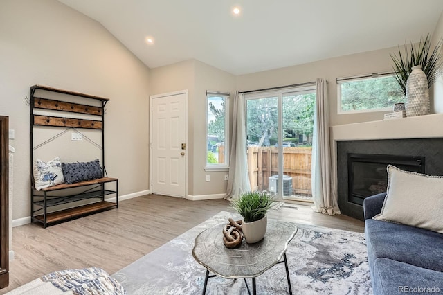 5150 Buckingham Rd, Boulder, CO 80301 - living room featuring wood finished floors, vaulted ceiling, a glass covered fireplace, and recessed lighting