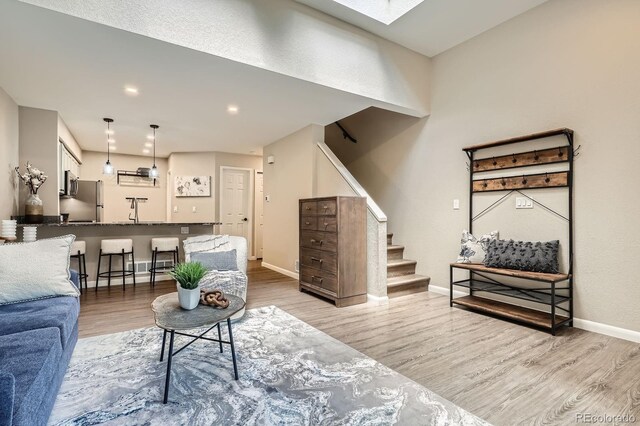 5150 Buckingham Rd, Boulder, CO 80301 - living area with stairs, light wood-style flooring, a skylight, and recessed lighting
