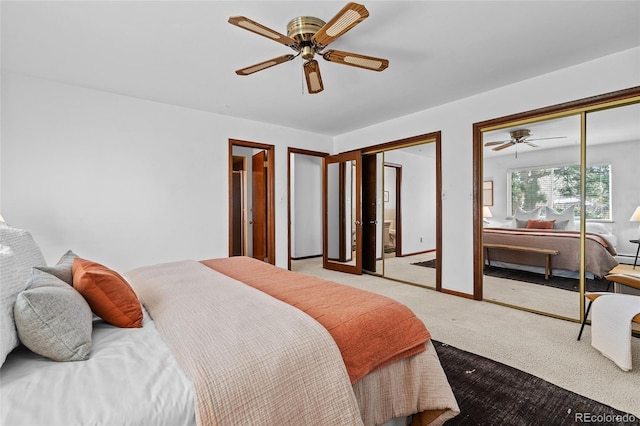 carpeted bedroom with multiple closets and ceiling fan