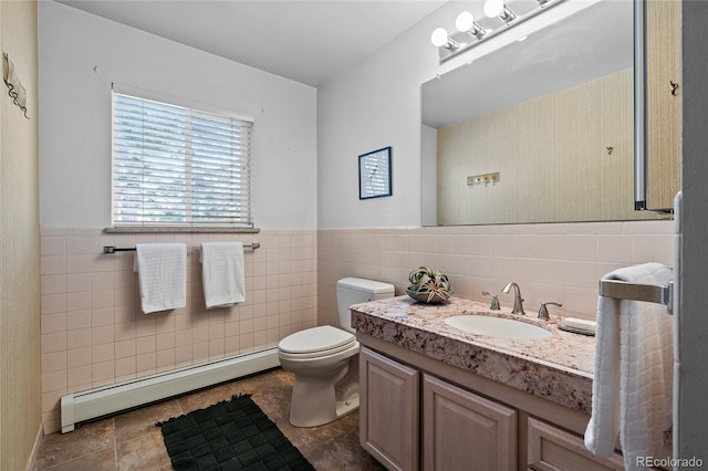 bathroom with a baseboard radiator, tile walls, vanity, and toilet