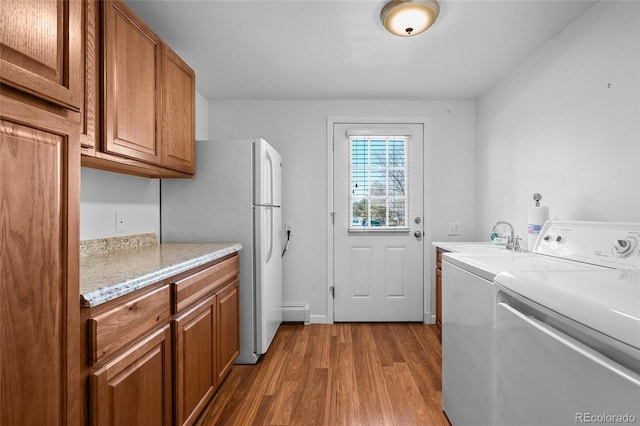 kitchen with sink, hardwood / wood-style flooring, and white refrigerator