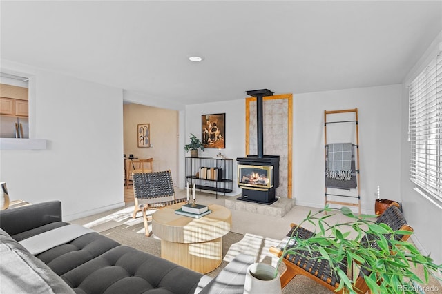 carpeted living room featuring a wood stove