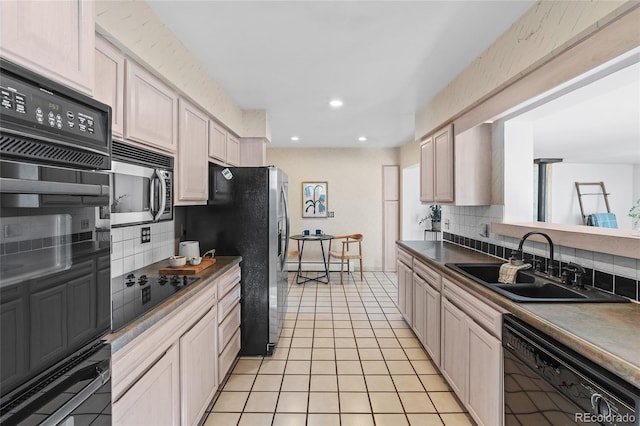 kitchen featuring light tile patterned floors, sink, decorative backsplash, and black appliances