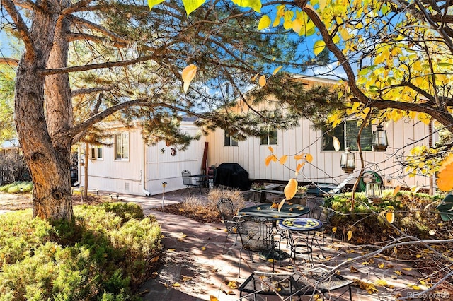 view of side of property featuring a patio area