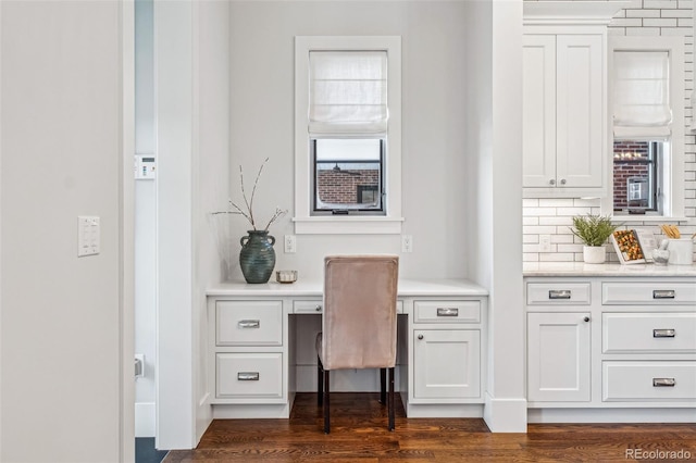 office area featuring dark hardwood / wood-style floors and built in desk