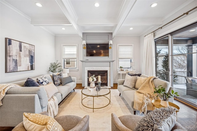 living room featuring a fireplace, beamed ceiling, ornamental molding, coffered ceiling, and light hardwood / wood-style floors