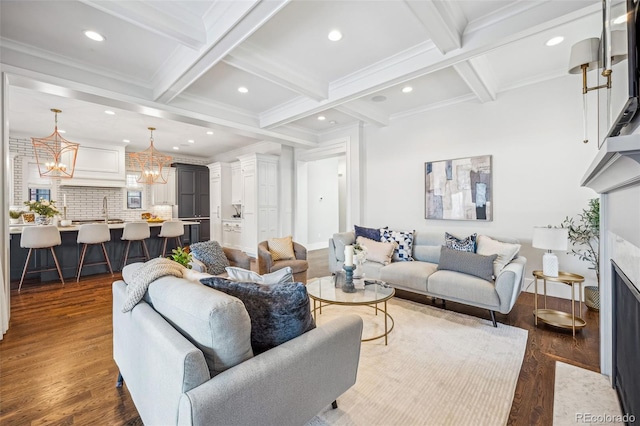 living room featuring beamed ceiling, dark hardwood / wood-style flooring, coffered ceiling, a high end fireplace, and crown molding