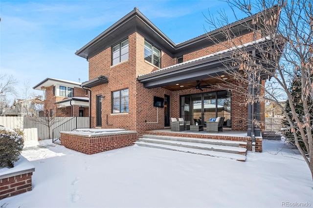 snow covered back of property featuring an outdoor hangout area and ceiling fan