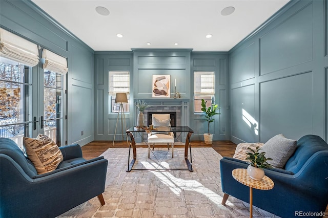 home office featuring a wealth of natural light, a decorative wall, and a fireplace