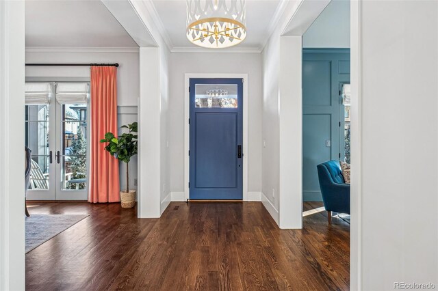 foyer entrance with french doors, an inviting chandelier, wood finished floors, and a healthy amount of sunlight