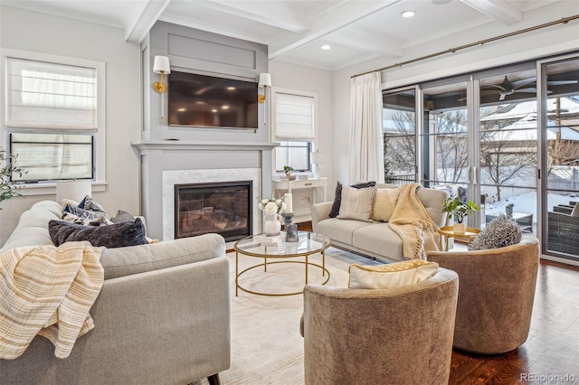 living area with recessed lighting, beam ceiling, coffered ceiling, a high end fireplace, and wood finished floors