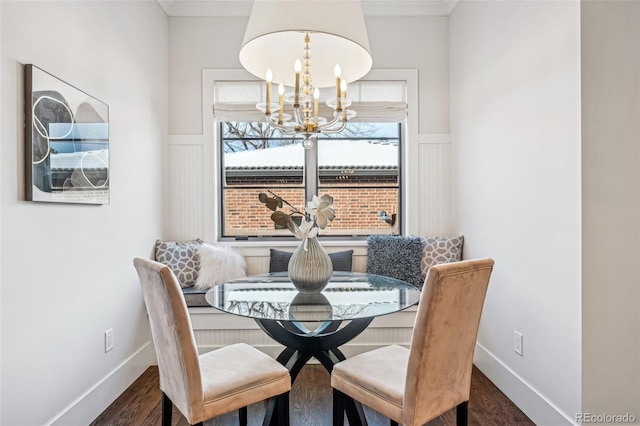 dining room featuring a chandelier, crown molding, and wood finished floors