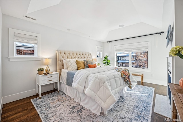 bedroom featuring visible vents, baseboards, and wood finished floors