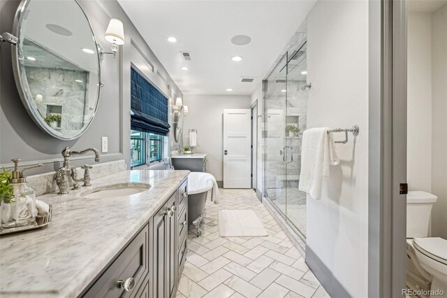 bathroom with vanity, a stall shower, recessed lighting, toilet, and visible vents